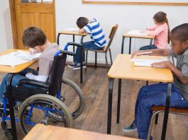 Disabled pupil writing desk classroom